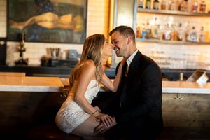 picture of couple sitting and laughing, holding each other, bar in san antonio, tx