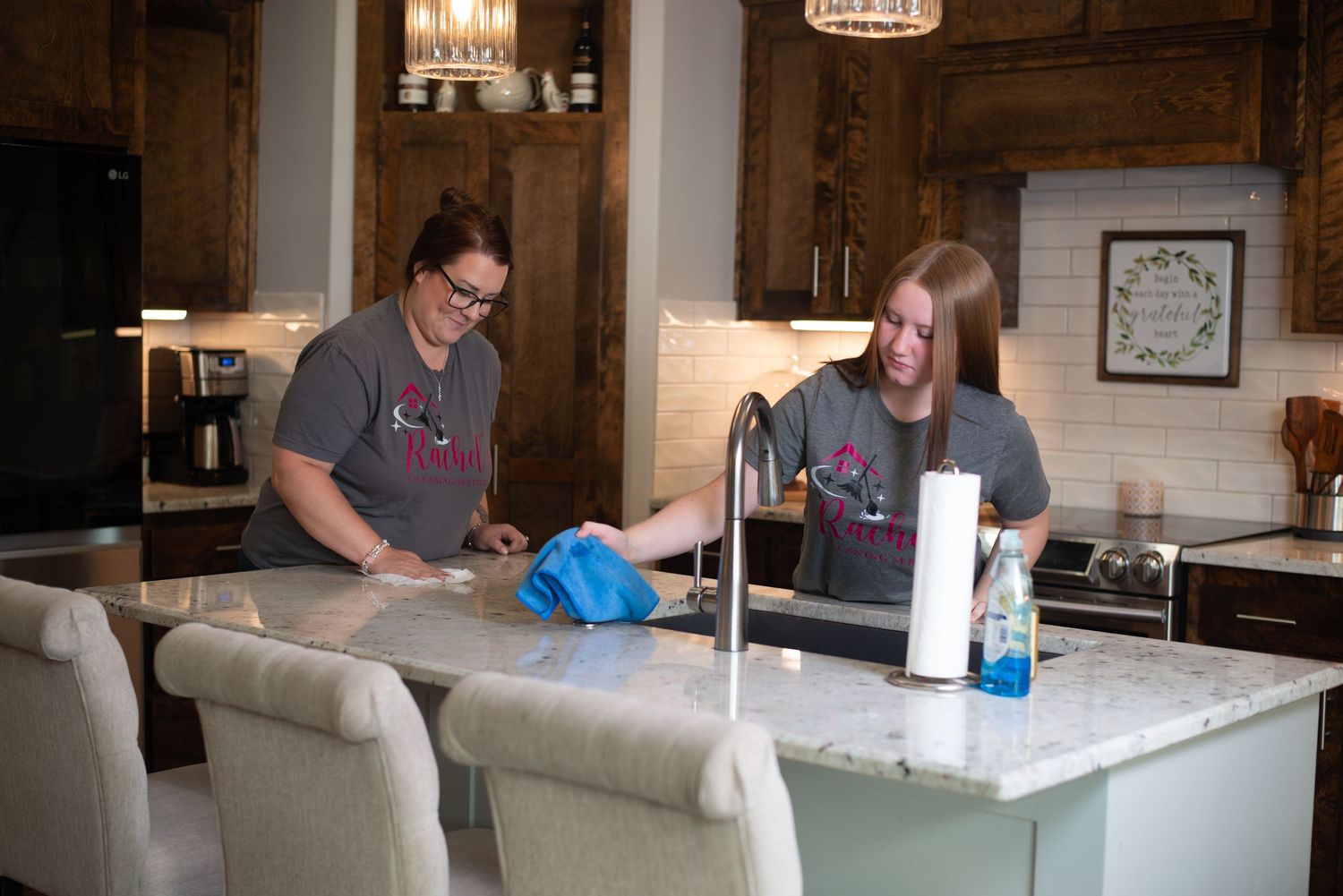 People working together at a long counter in a rustic industrial space.