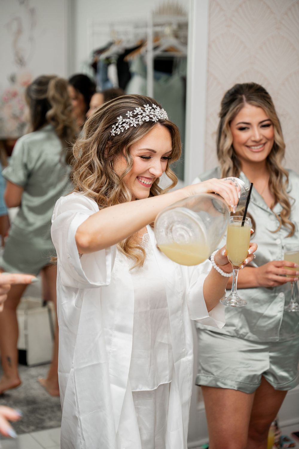 Person in white robe taking photos while getting ready on wedding morning.