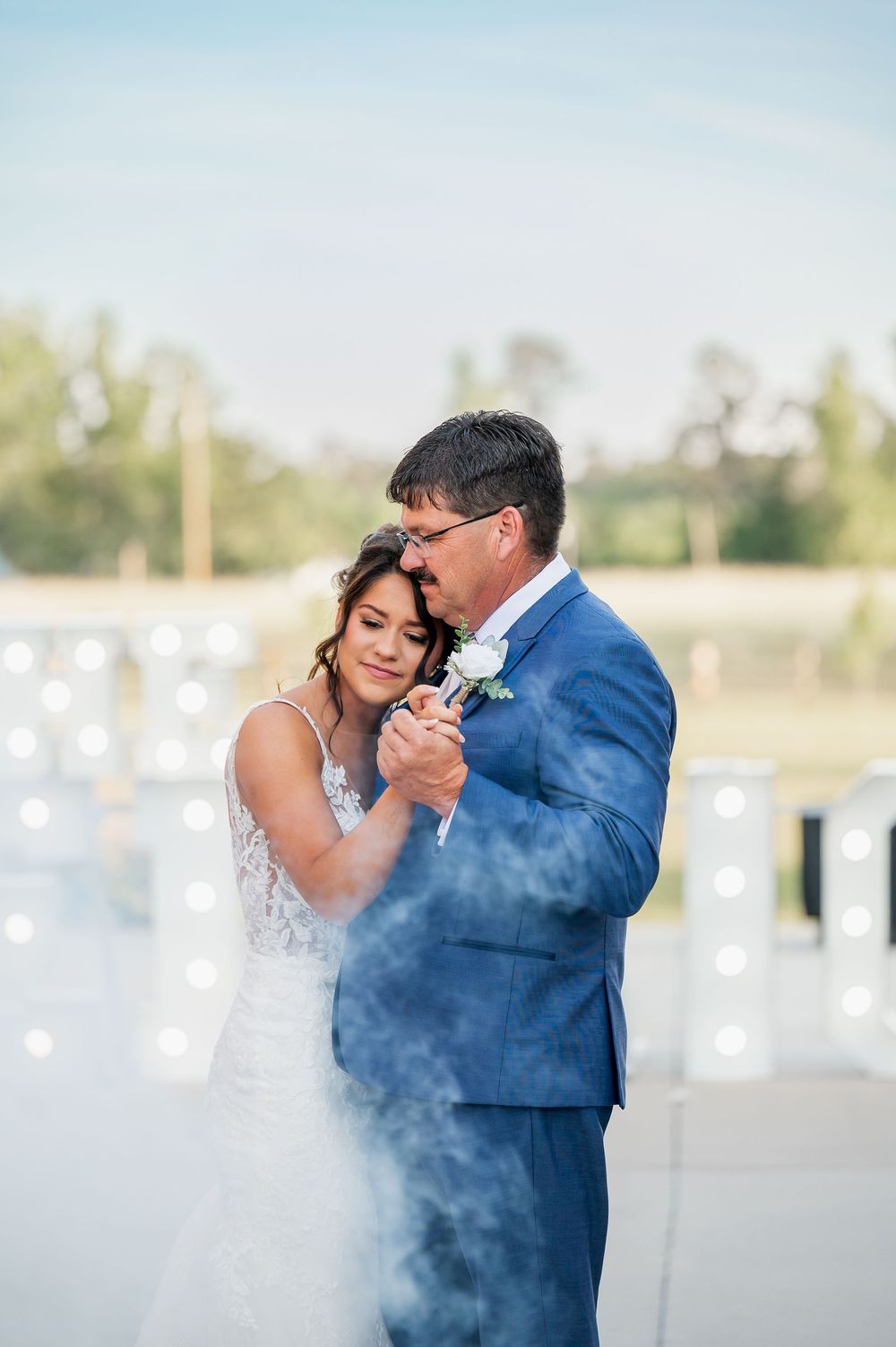 A romantic dance sequence with smoke effects creating a dramatic atmosphere against a waterfront backdrop.