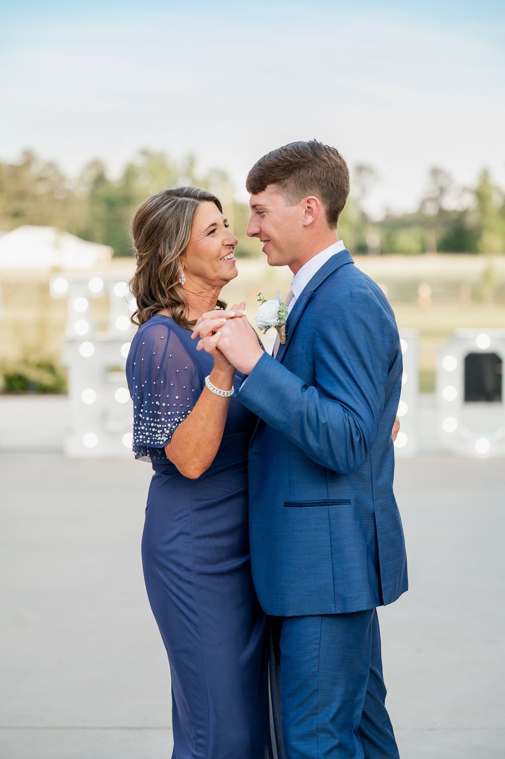 A series of intimate dance moments captured at an outdoor wedding venue with bright natural lighting.