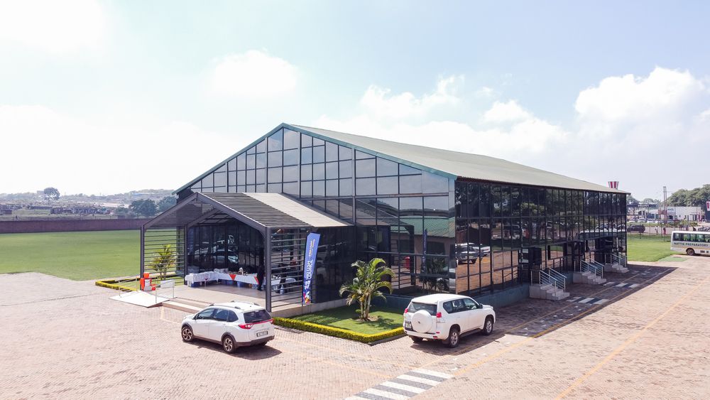 Panoramic view of modern greenhouse structures with glass roofs and agricultural facilities stretching across the landscape.