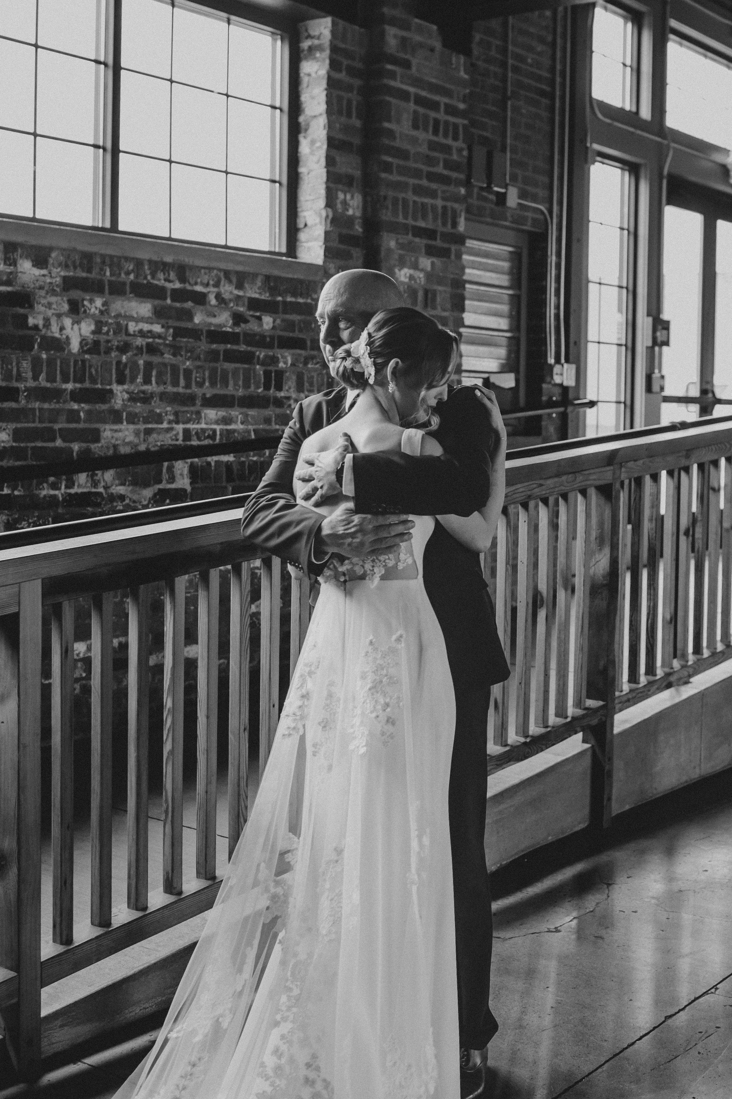 A romantic black and white photo series shows a couple embracing on a porch with white railings.