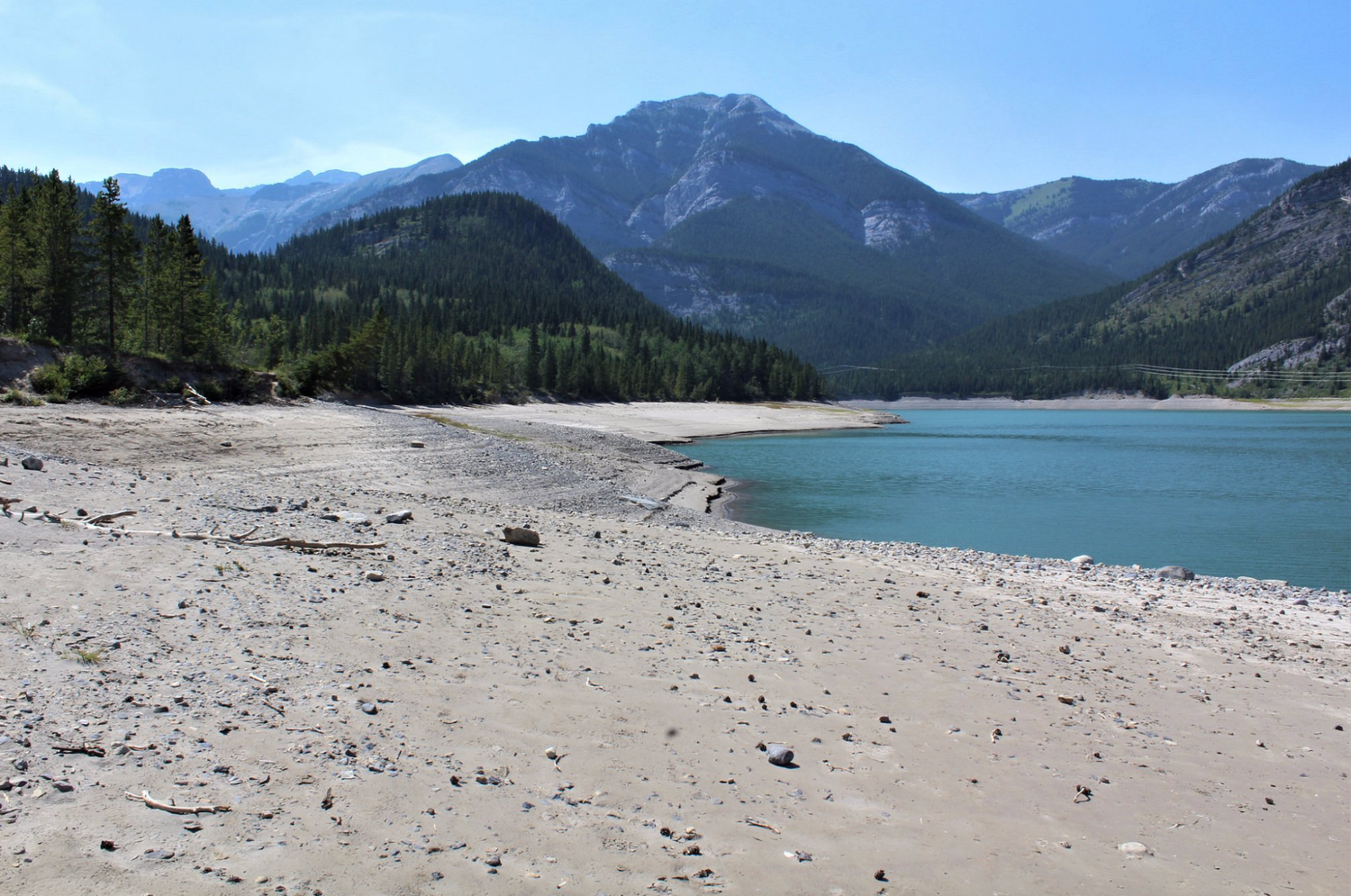 sandy beach at Barrier Lake in Kananaskis with mountains in the background
