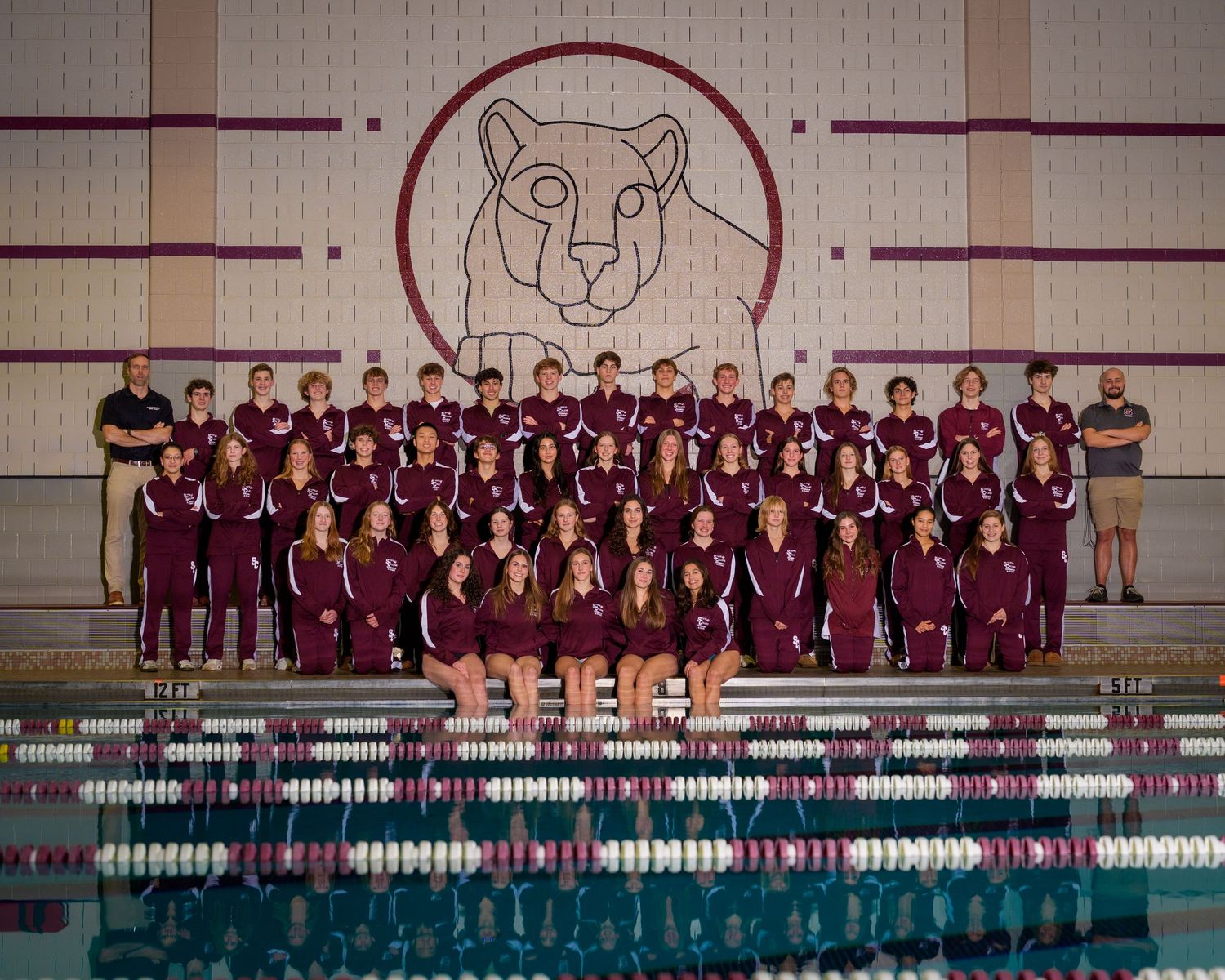 State College High School swim team with maroon warmup and little nittny lion background, by SportsFox Photography, State College, PA