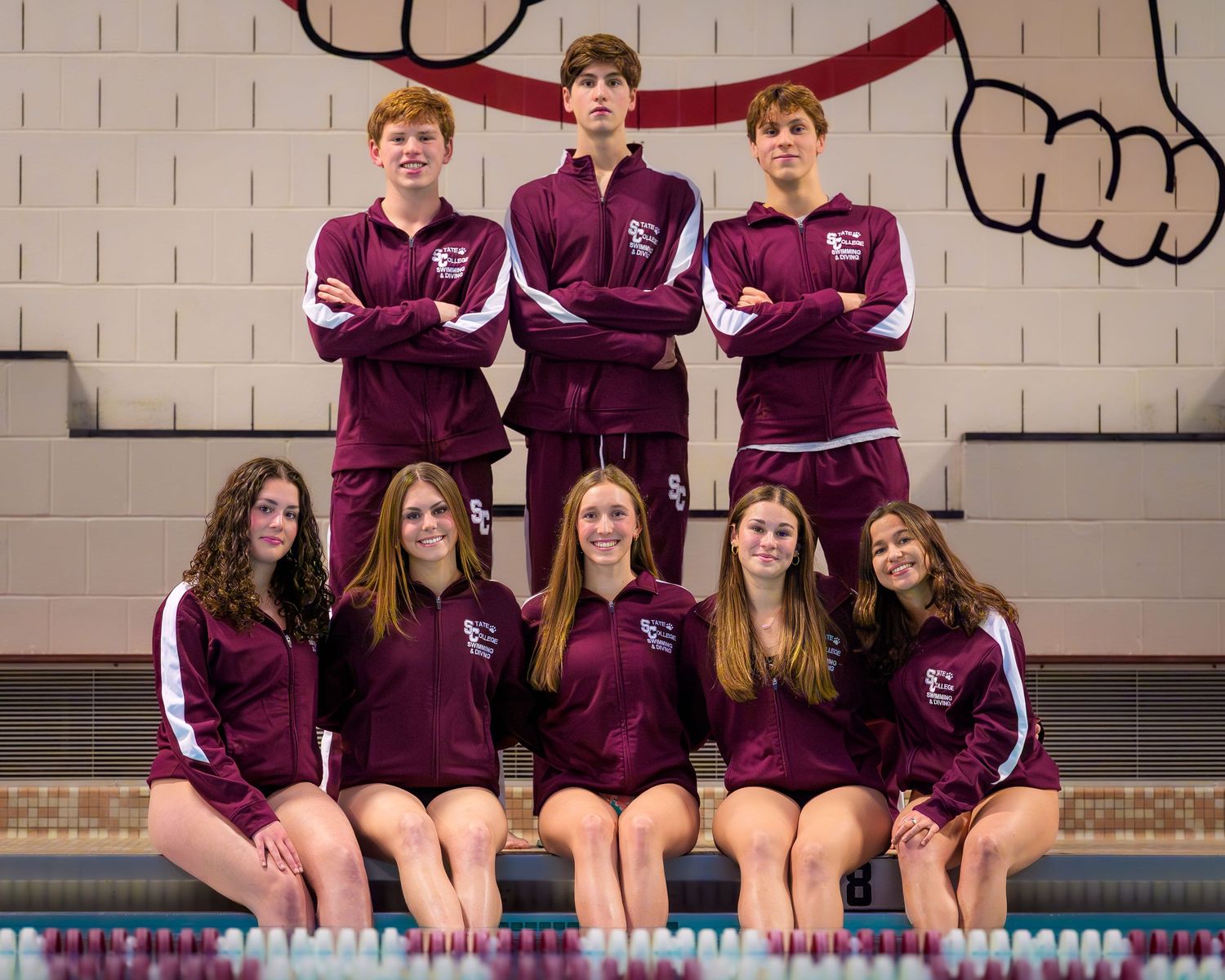 State College High School Swimming Seniors with maroon warmup and little nittny lion background, by SportsFox Photography, State College, PA