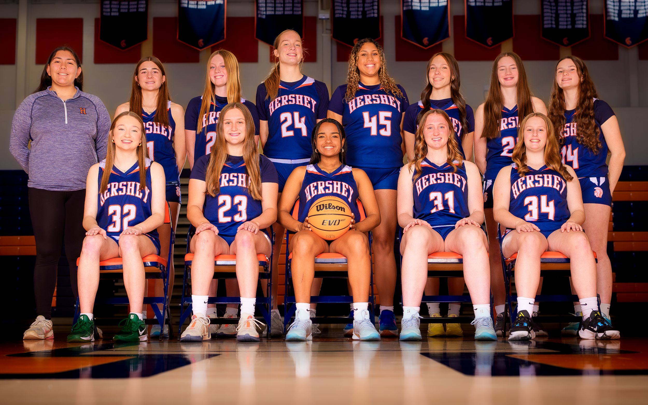 Hershey youth basketball girls team group portrait in blue uniforms, coaches and players in gym, team photo day by SportsFox Photography.