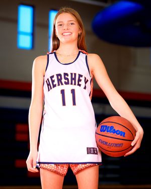 Basketball player in Hershey jersey #11, holding basketball, individual portrait from team photo day, Hershey PA.