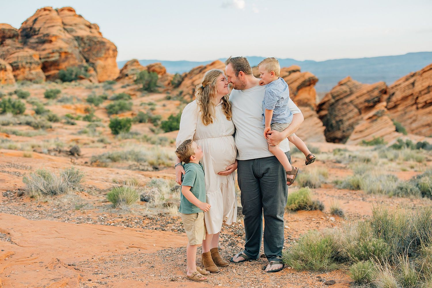 Couple walking together through scenic red rock formations in Valley of Fire State Park at sunset.