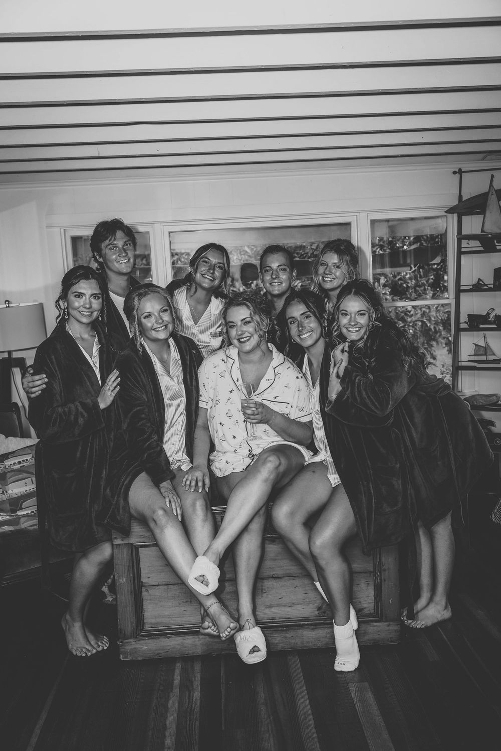 The bridal party posing in their robes in black and white before they dress in their formal attire