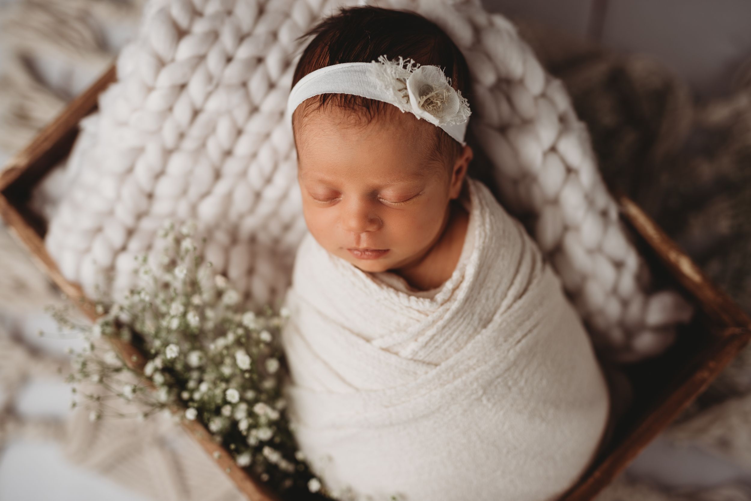 Newborn baby wrapped in cream clanked during studio newborn photography session in Etobicoke