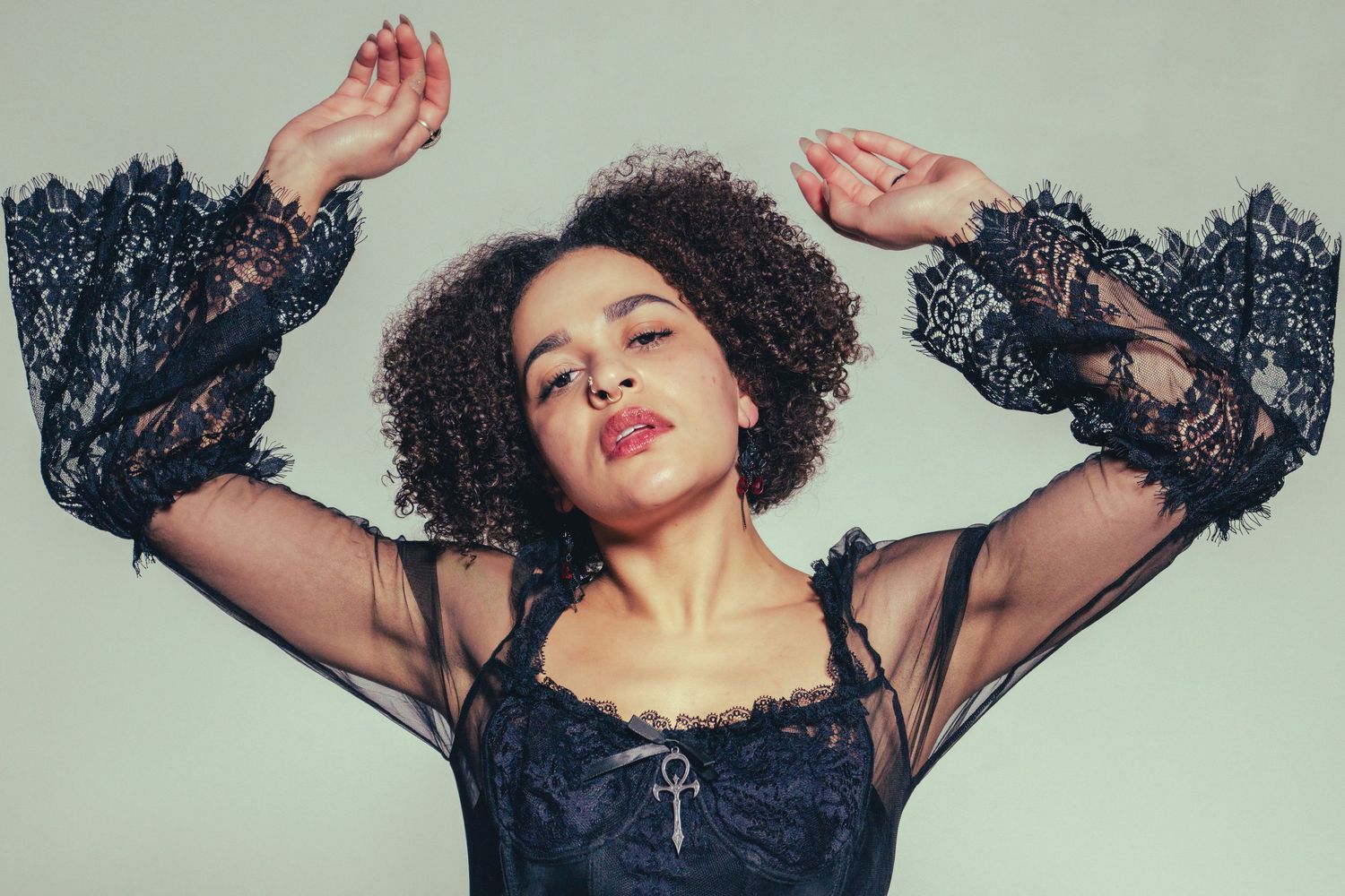 Fashion portrait series with mint green background showing dynamic poses in black lace outfit.
