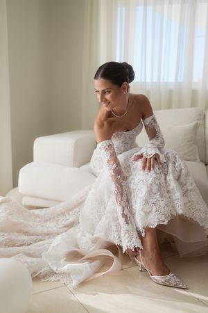 An elegant bridal portrait showcasing delicate lace details and wedding shoes.