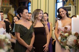 Wedding celebration scene with guests in formal attire enjoying festivities in an elegant yellow room.