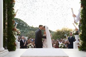 Wedding celebration sequence with confetti toss against scenic outdoor backdrop.