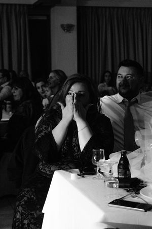 Wedding guests seated at tables during an evening reception.