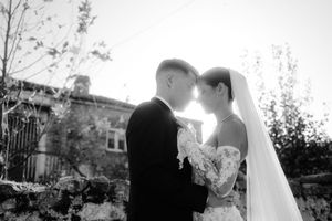 Black and white wedding portraits captured in a dreamy outdoor setting.