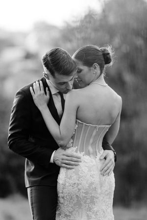 A series of romantic black and white wedding photos showing intimate moments between a couple in formal attire.
