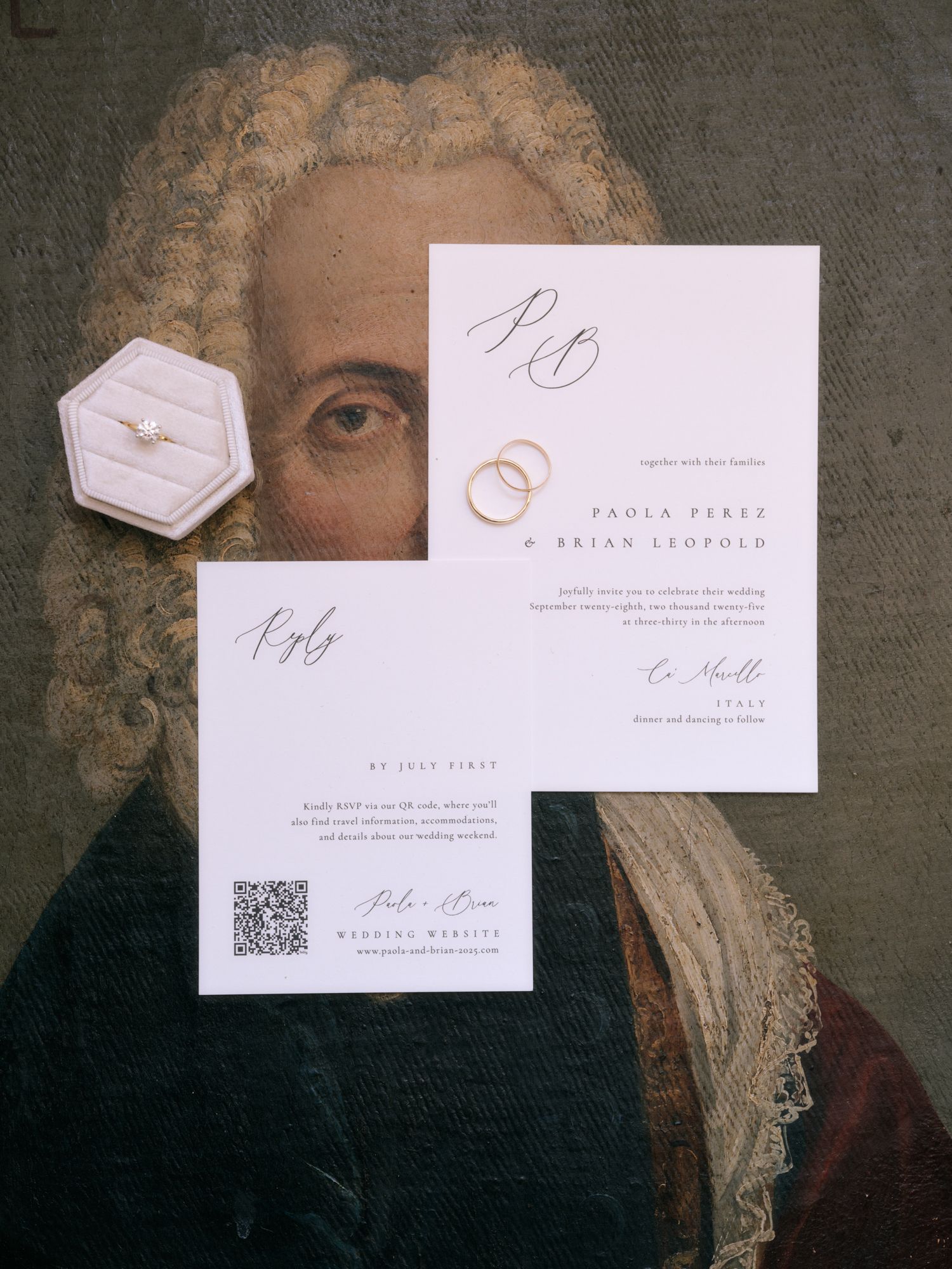Minimalist white wedding stationery with calligraphy and QR codes displayed against a vintage portrait background.