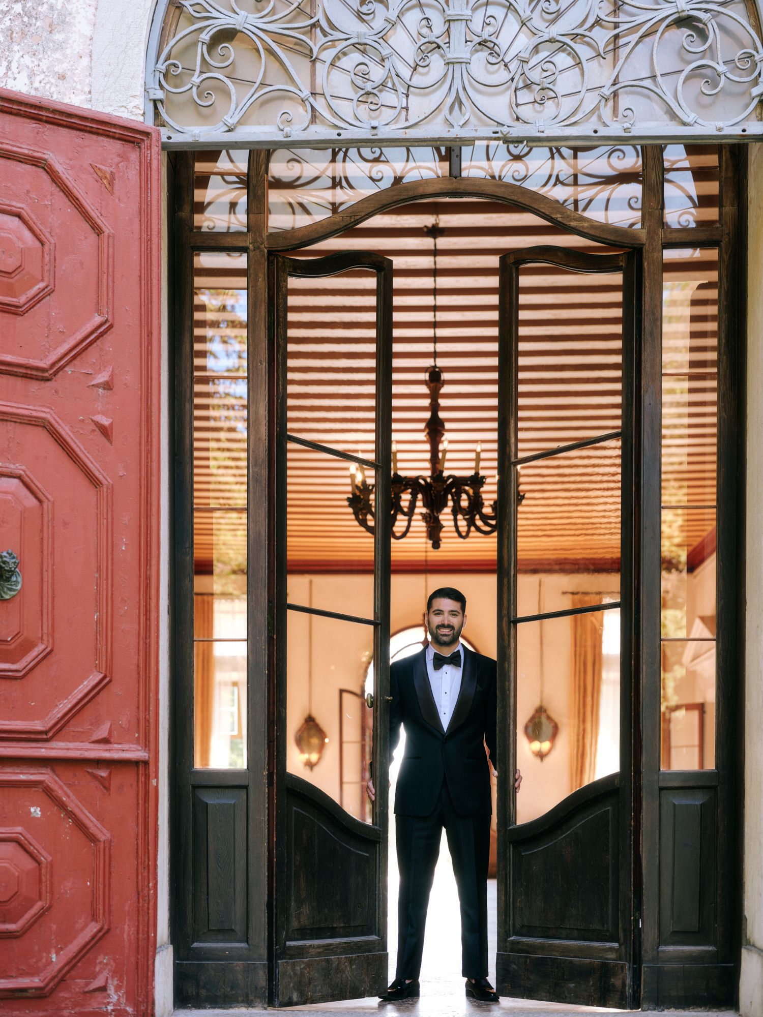 A series of elegant black and white photos showing someone in a tuxedo standing in ornate doorways with decorative details.