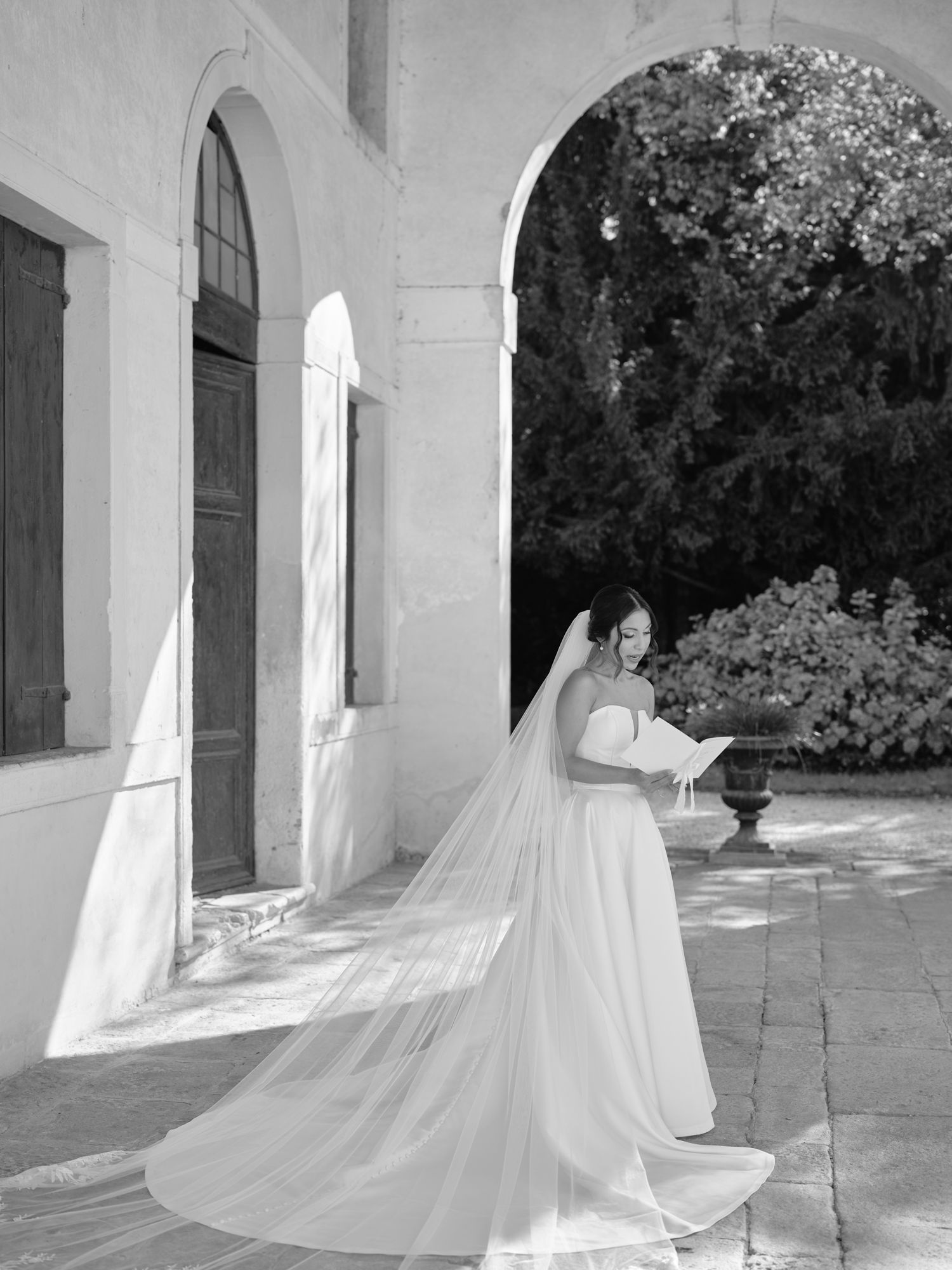 A series of ethereal photographs showing a flowing white dress moving gracefully through an arched colonnade.