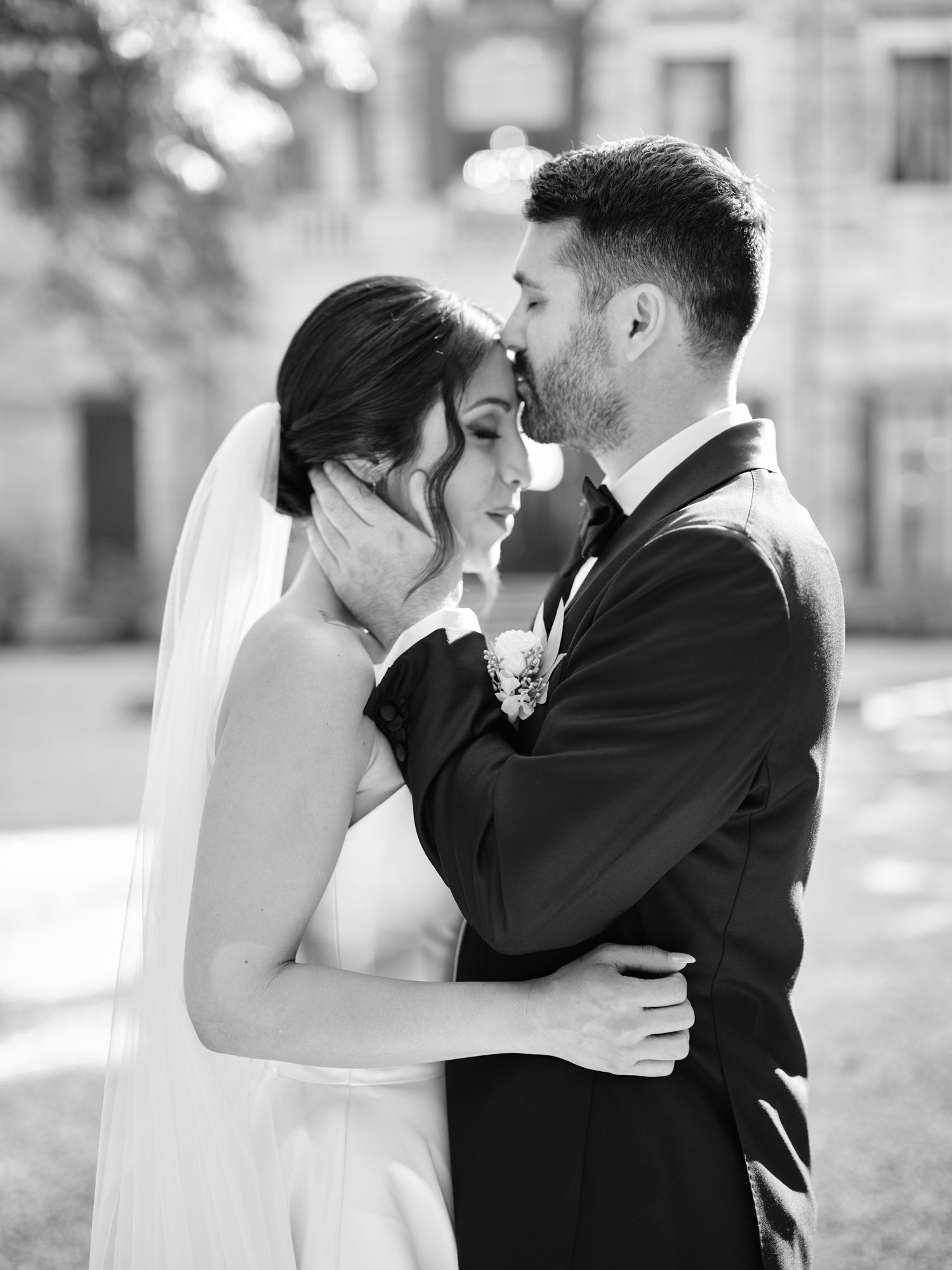 A romantic black and white wedding photo series showing tender moments between a bride and groom embracing outdoors.