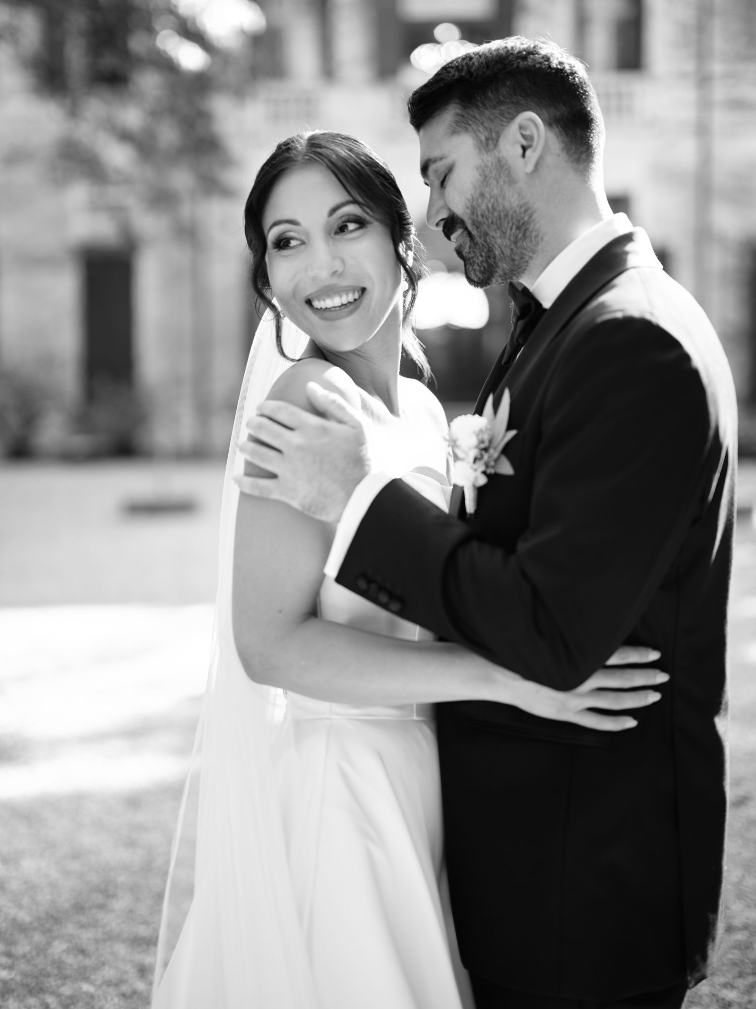 A romantic black and white wedding photo series showing a couple embracing in four tender moments.