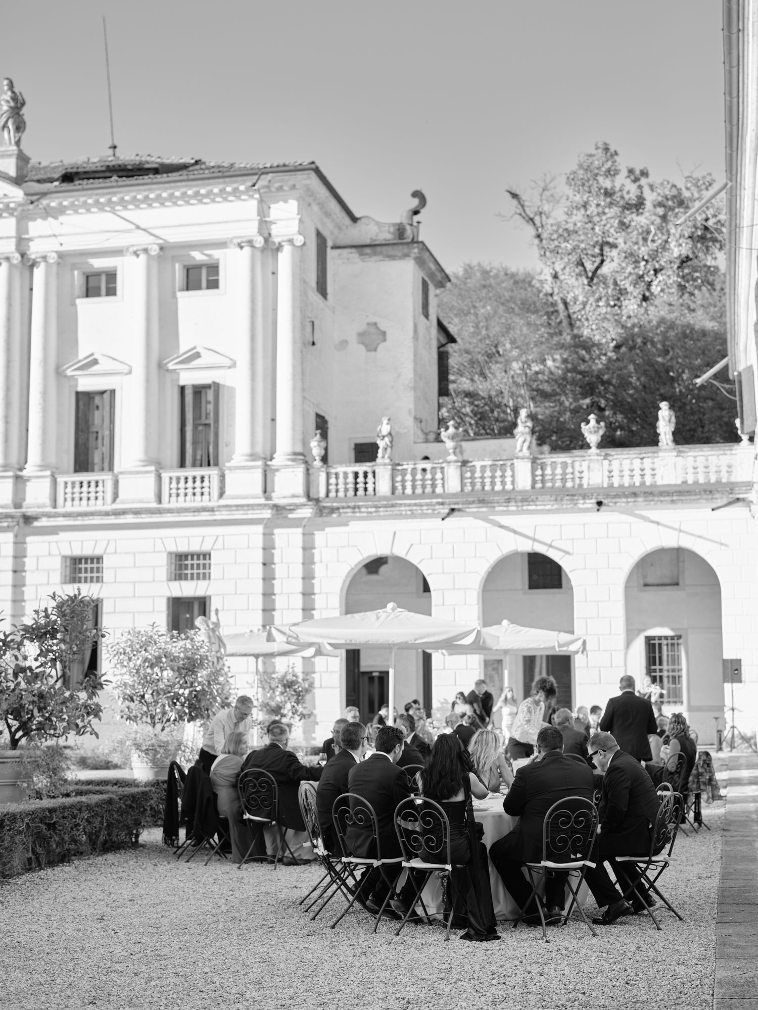 A series of vintage black and white photographs showing people seated outdoors at a formal gathering or event.