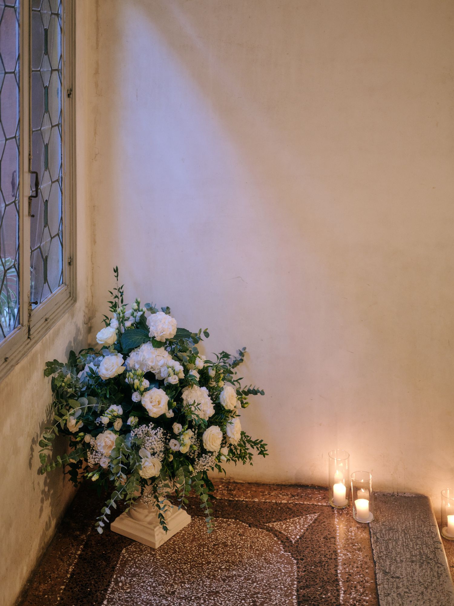 A sequence of church altar photos showing white floral arrangements and candles on a textured brown surface in soft lighting.