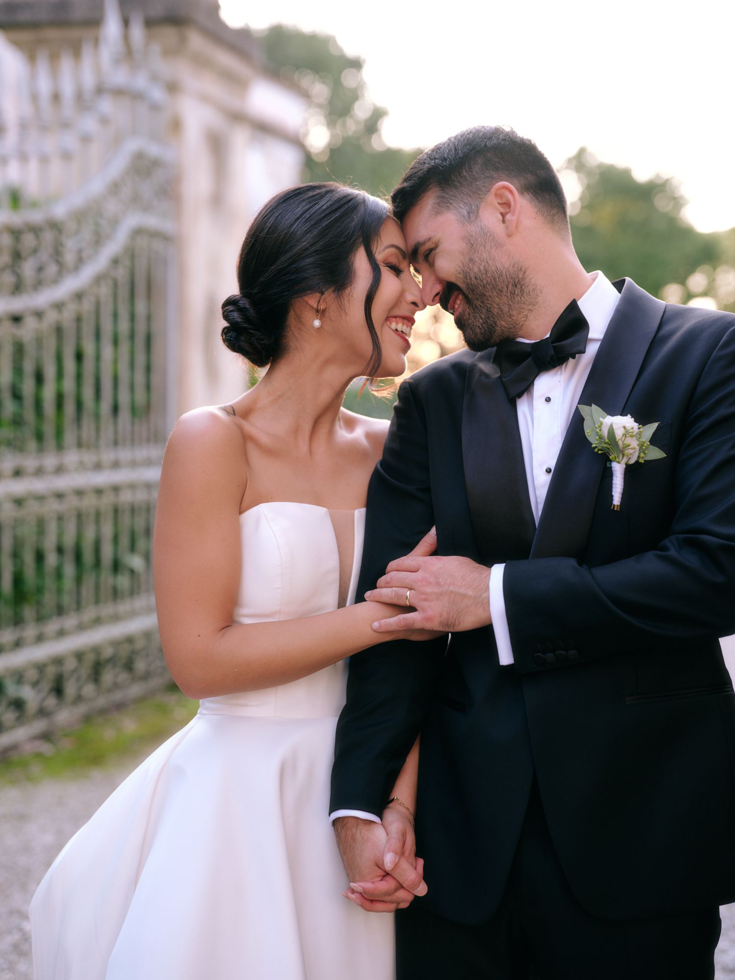 Romantic wedding couple shares tender moments in a series of intimate outdoor portraits at sunset.