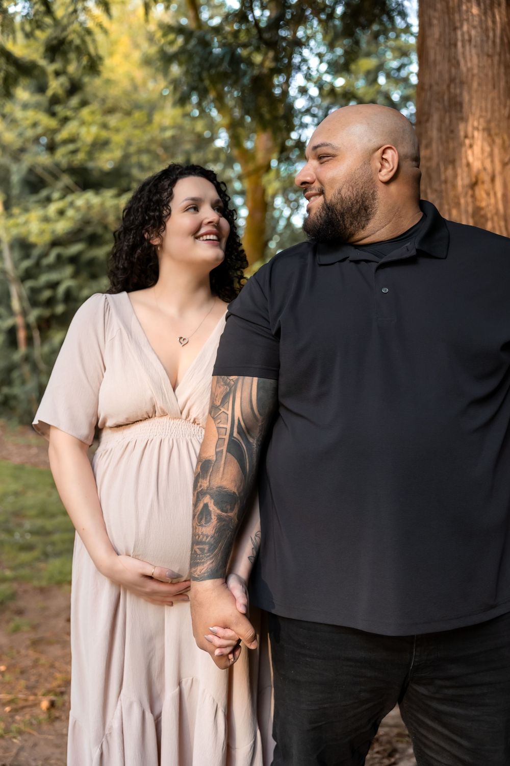 A couple in love shares tender moments in a forest setting during a romantic outdoor photo session.