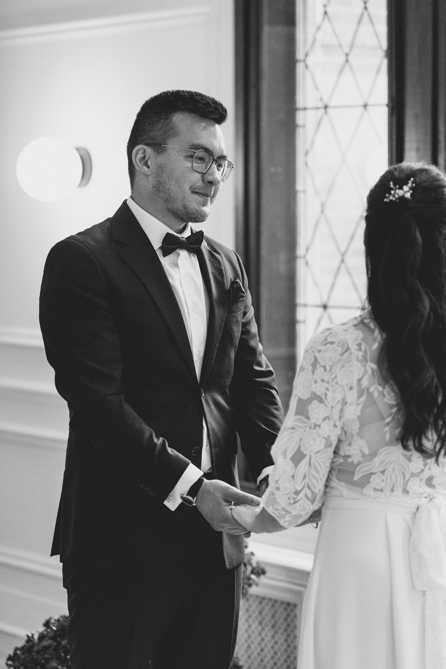 A series of black and white wedding photos showing intimate moments between a couple during their ceremony.