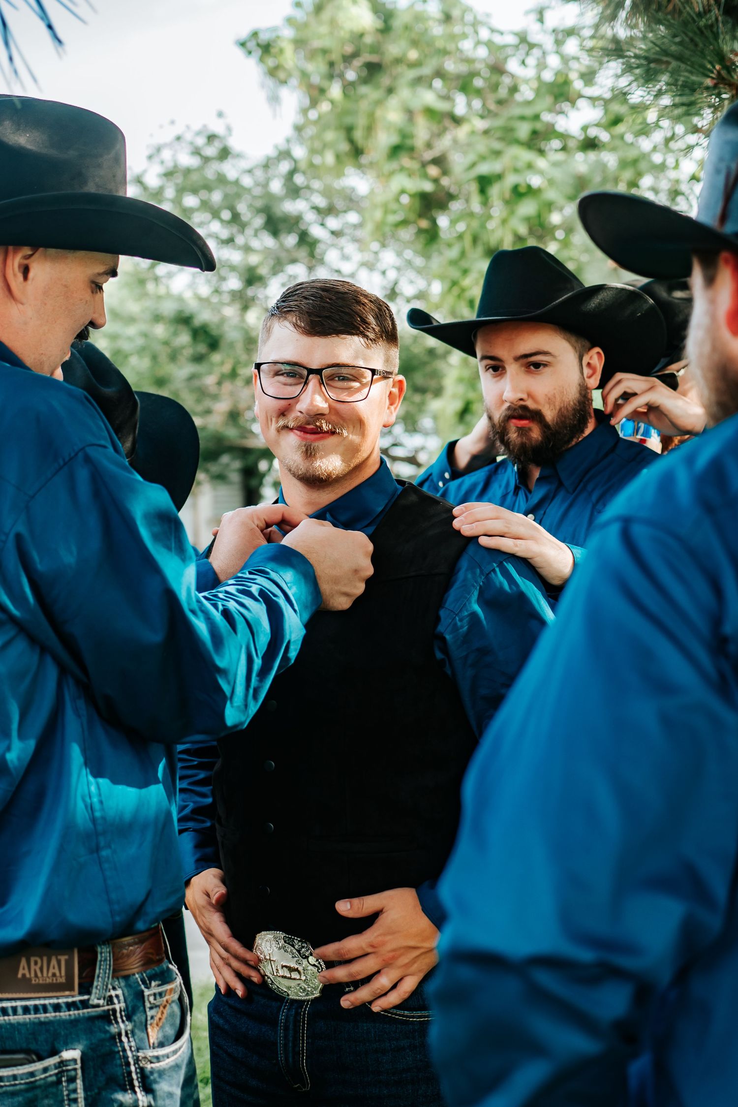 Groom and groomsmen getting ready for a rustic pasture wedding in Eastern Oregon.