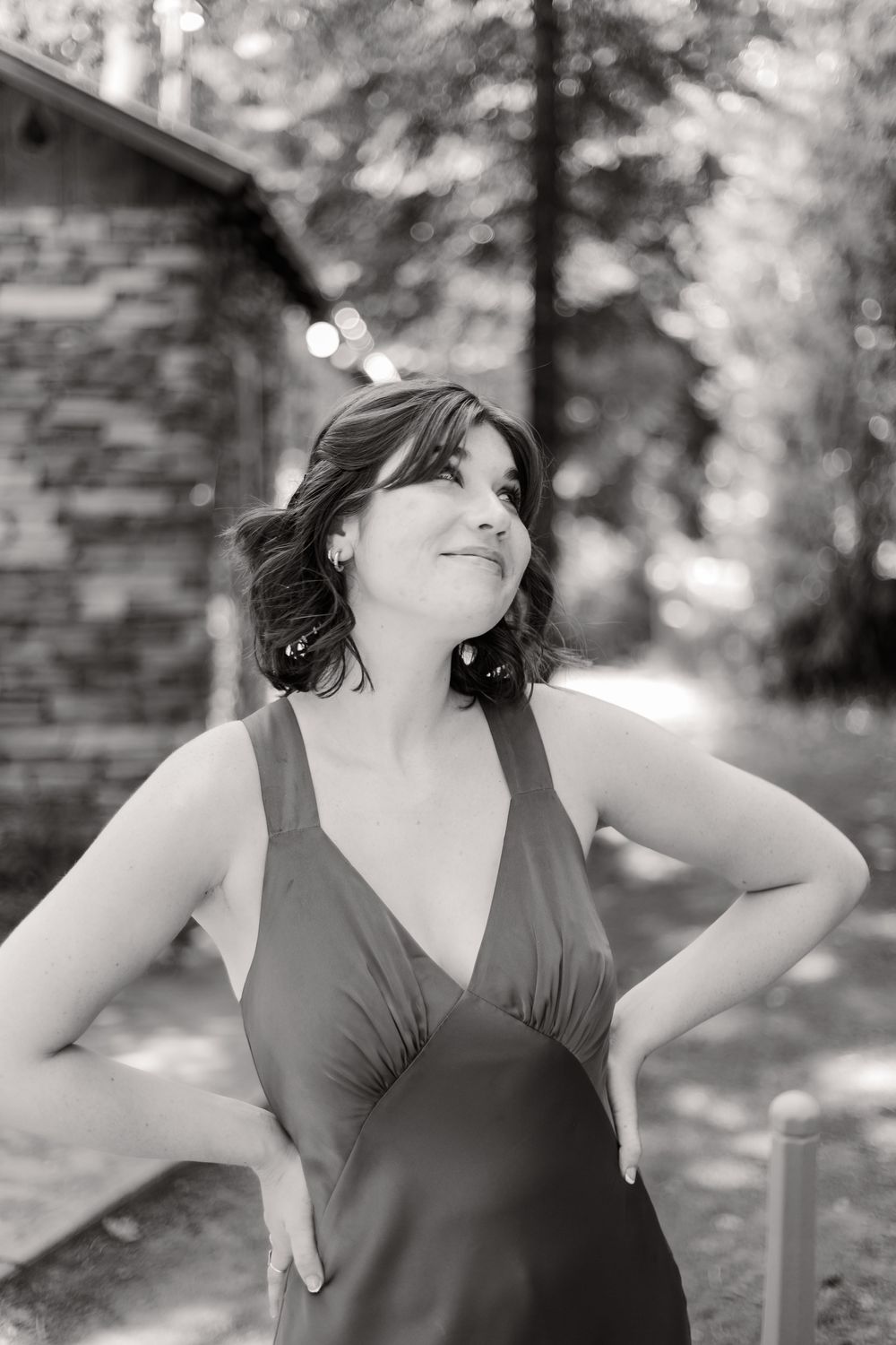 Black and white portrait series showing joyful expressions and natural poses in an outdoor setting.
