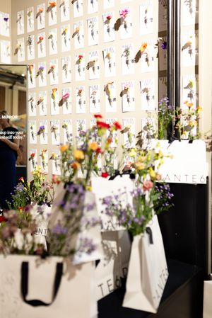 Wall display featuring paper designs with colorful flower arrangements in vases.