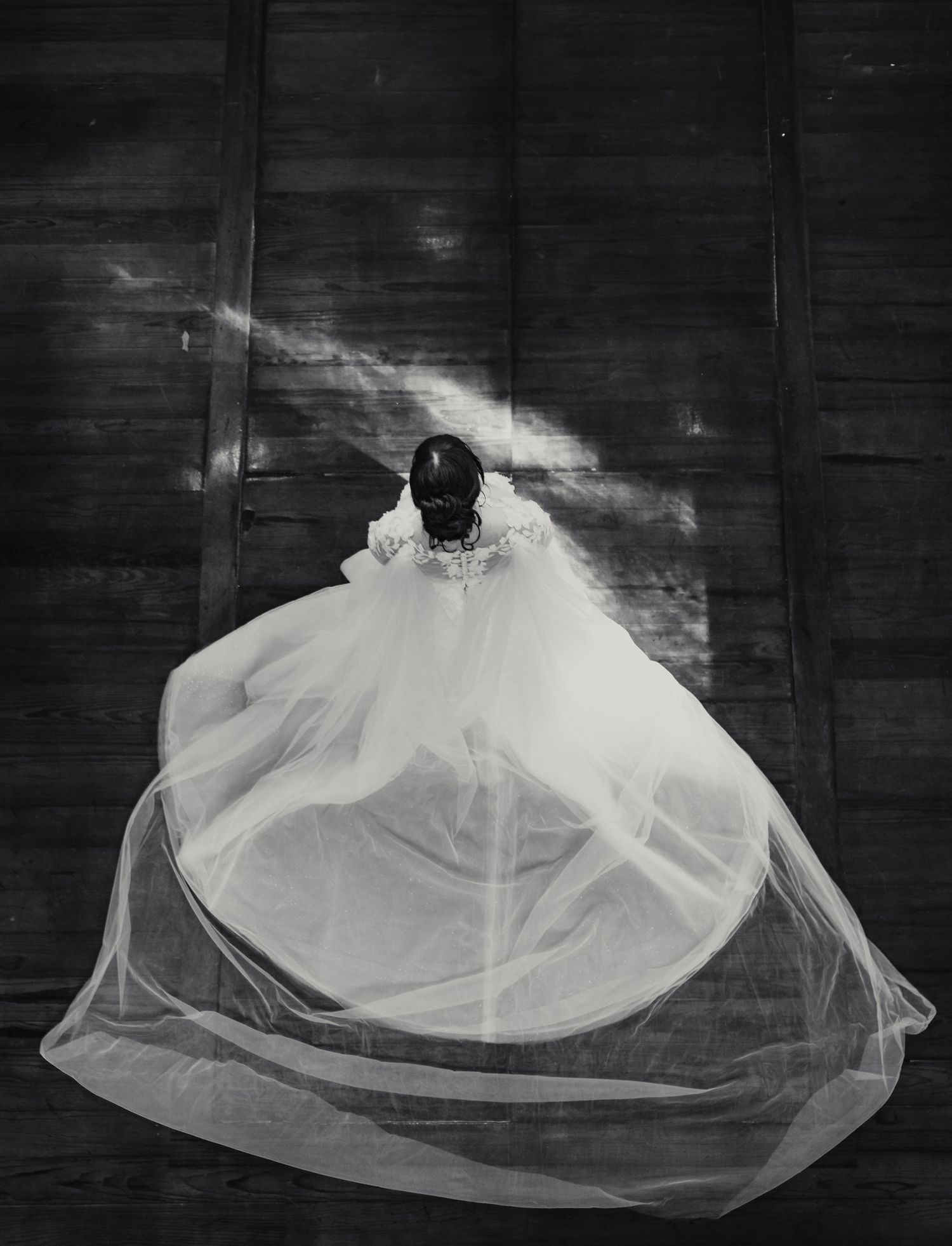 A flowing white veil creates an ethereal movement effect in a series of black and white photographs.