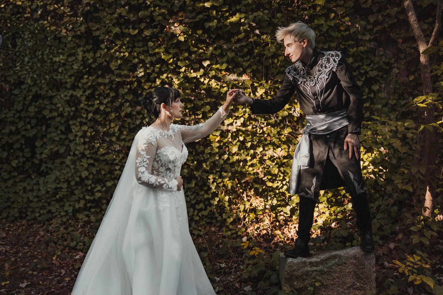 A magical fairytale-inspired wedding photo with a bride in white reaching up to her groom who appears to be floating in the air.