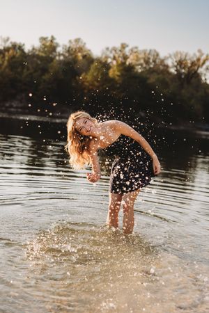 senior girl Klondike Park splashing water blonde hair blue dress