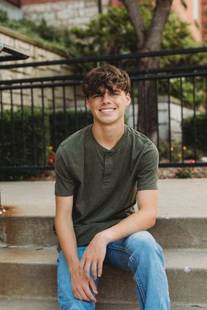 senior boy sitting on steps
