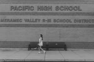 Graduate senior girl white dress cap and gown black and white movement pacific high school