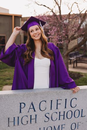 Graduate senior girl white dress purple cap and tassel and gown golden hour pacific high school