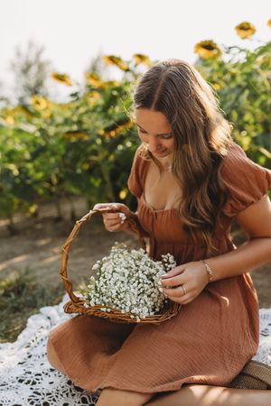 senior girl basket with baby breath flowers sunflowers behind her