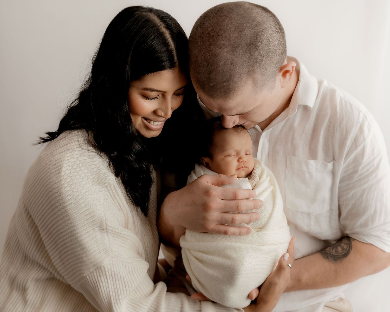 Family portrait with newborn baby in photography studio