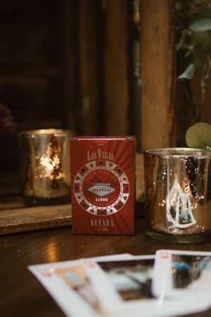 Las Vegas themed wedding favor playing cards box with gold mercury glass candle holders.