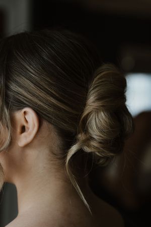 Elegant low bun hairstyle on a woman viewed from behind.