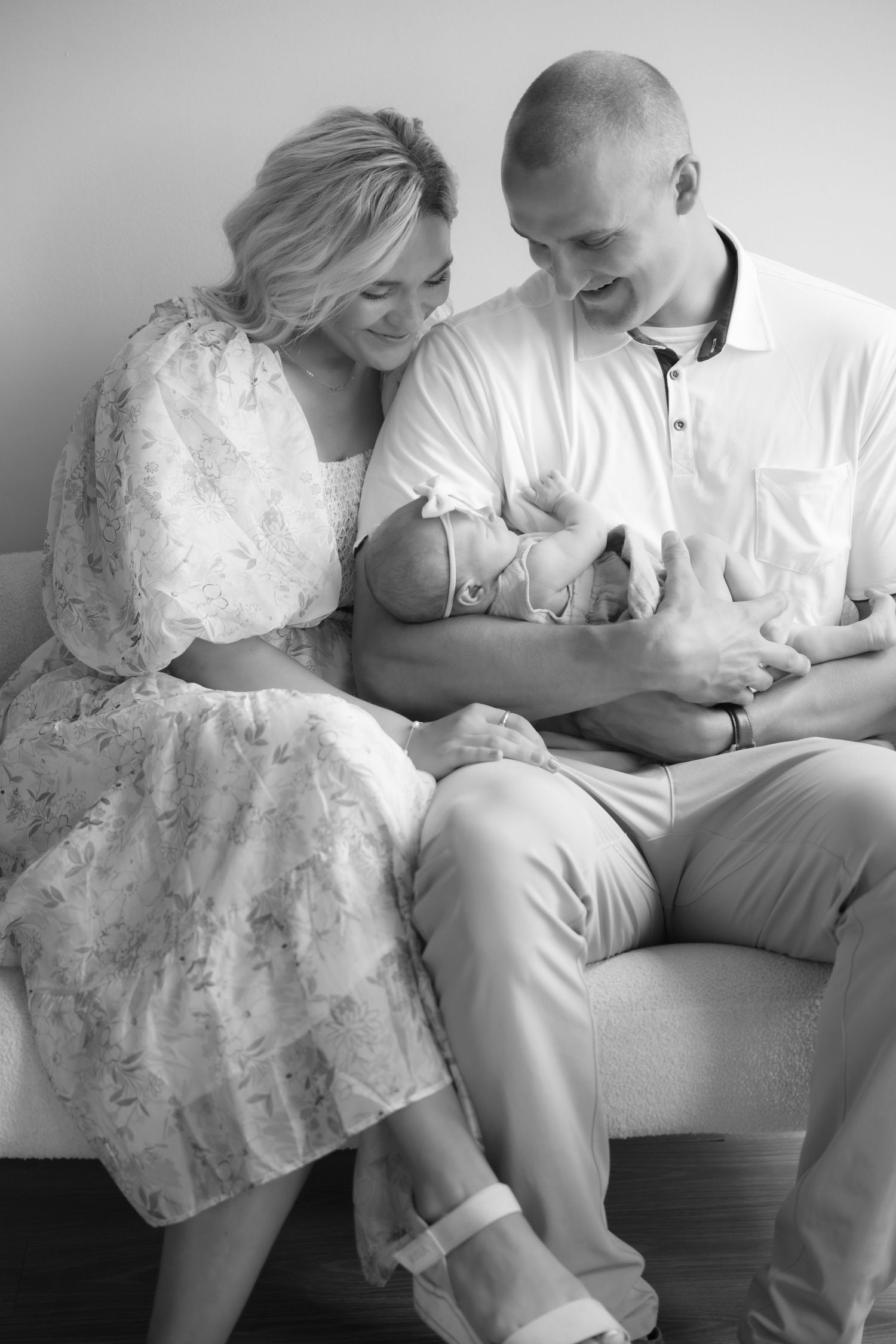 black and white portrait of parents admiring sleeping newborn during in studio lifestyle newborn session in stillwater, mn