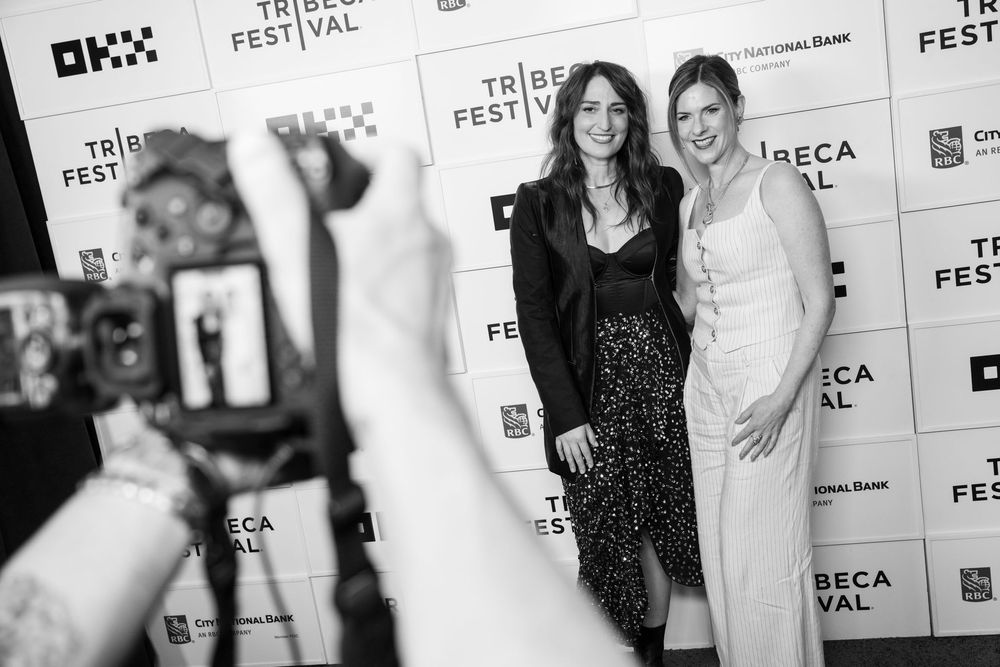Two women pose together on the Tribeca Festival red carpet in black and white photo.