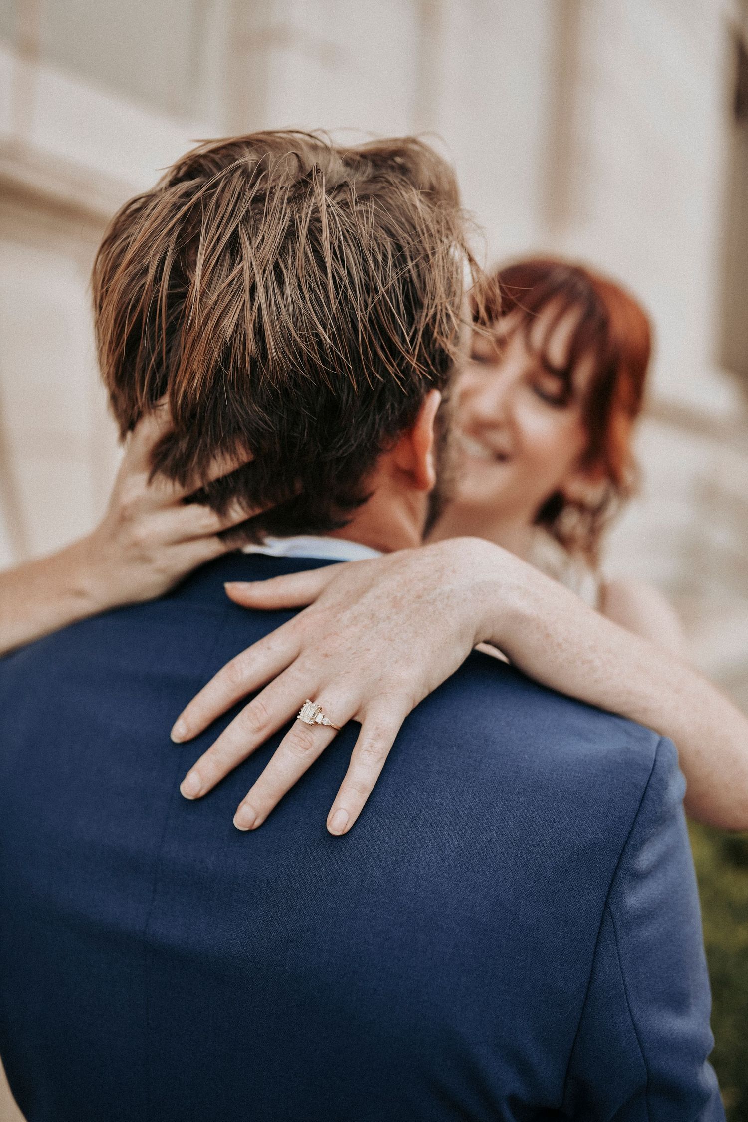 Couple embracing in front of Gothic Revival building in Downtown Dallas