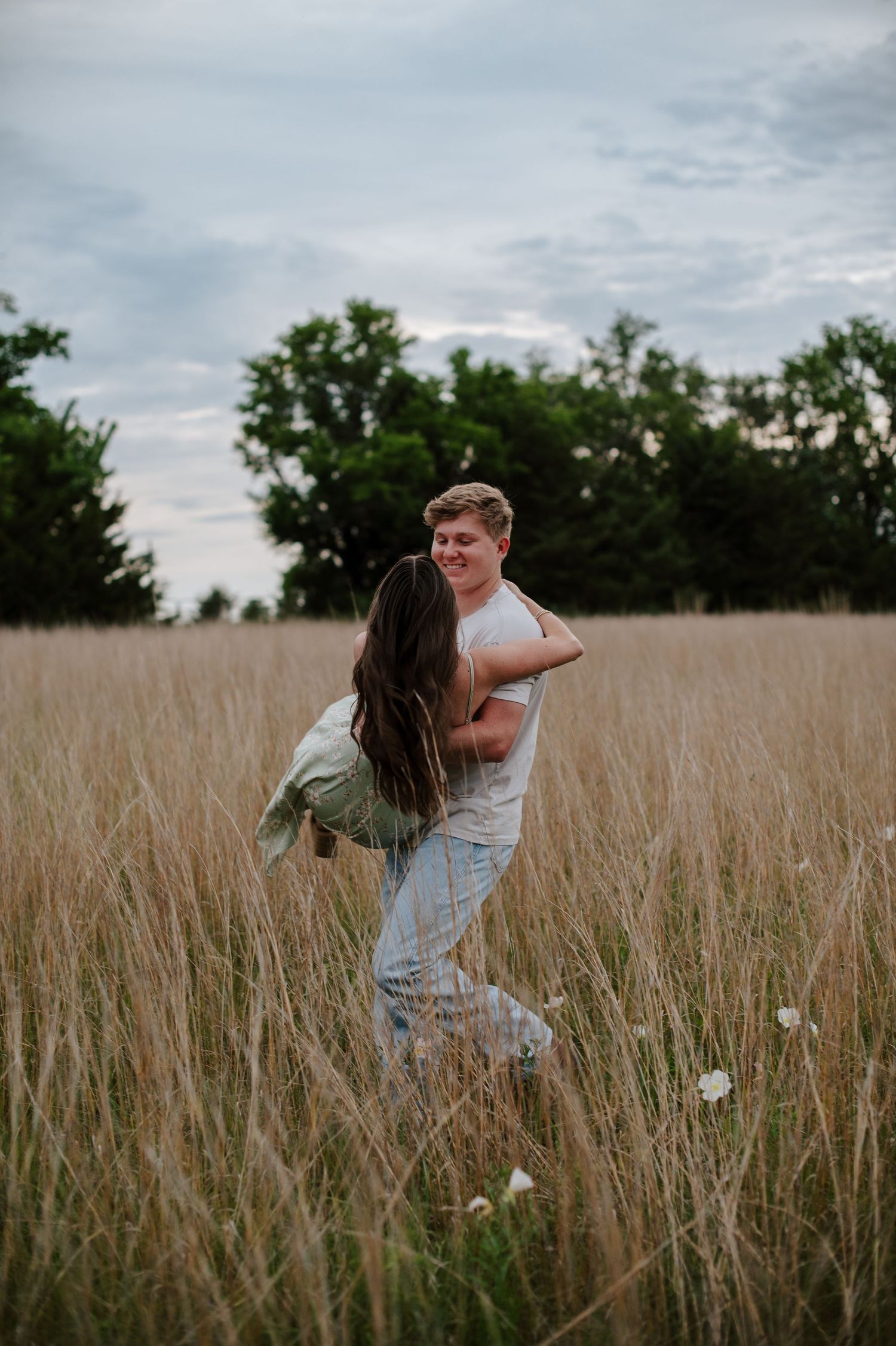 Wichita KS outdoor engagement photos in nature location Andover, couple photos in field with flowers, small elopement wedding photographer