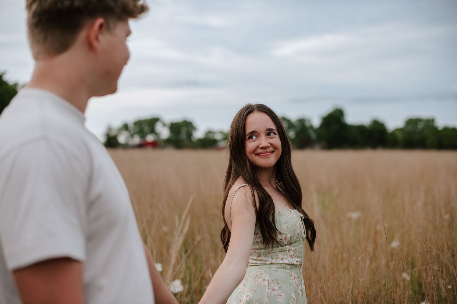 Wichita KS outdoor engagement photos in nature location Andover, couple photos in field with flowers, small elopement wedding photographer